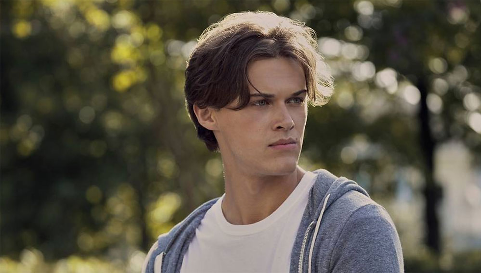 Christopher Briney posing at an event, showcasing his signature charm as a rising actor in 2025.