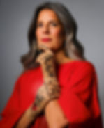 Empowerment portrait of woman with gray hair in red dress wearing tattoo-print gloves — empowerment photography by Violetta Markelou, Miami.