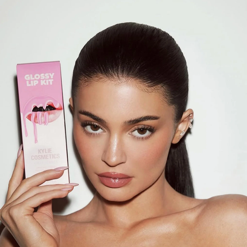 Kylie Jenner showing off her famous Kylie Cosmetics Lip Kit — the billion-dollar beauty brand that turned social media influence into a cosmetics empire.