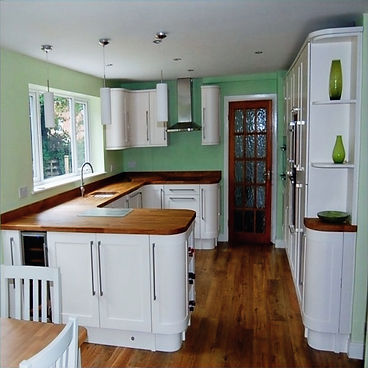 Cream painted shaker kitchen with wooden worktops