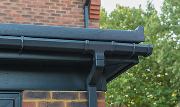 Glass reinforced polyester roof with anthracite soffits, fascias and guttering. Close up d