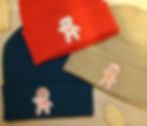 knitted beanie hats with gingerbread man embroidered on the cuff