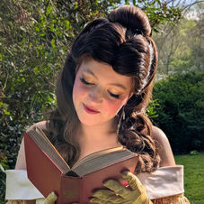 Belle looking down at a book, party princess belle character