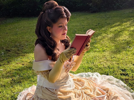 princess reading a book, waiting for someone to book her for their event or childrens party