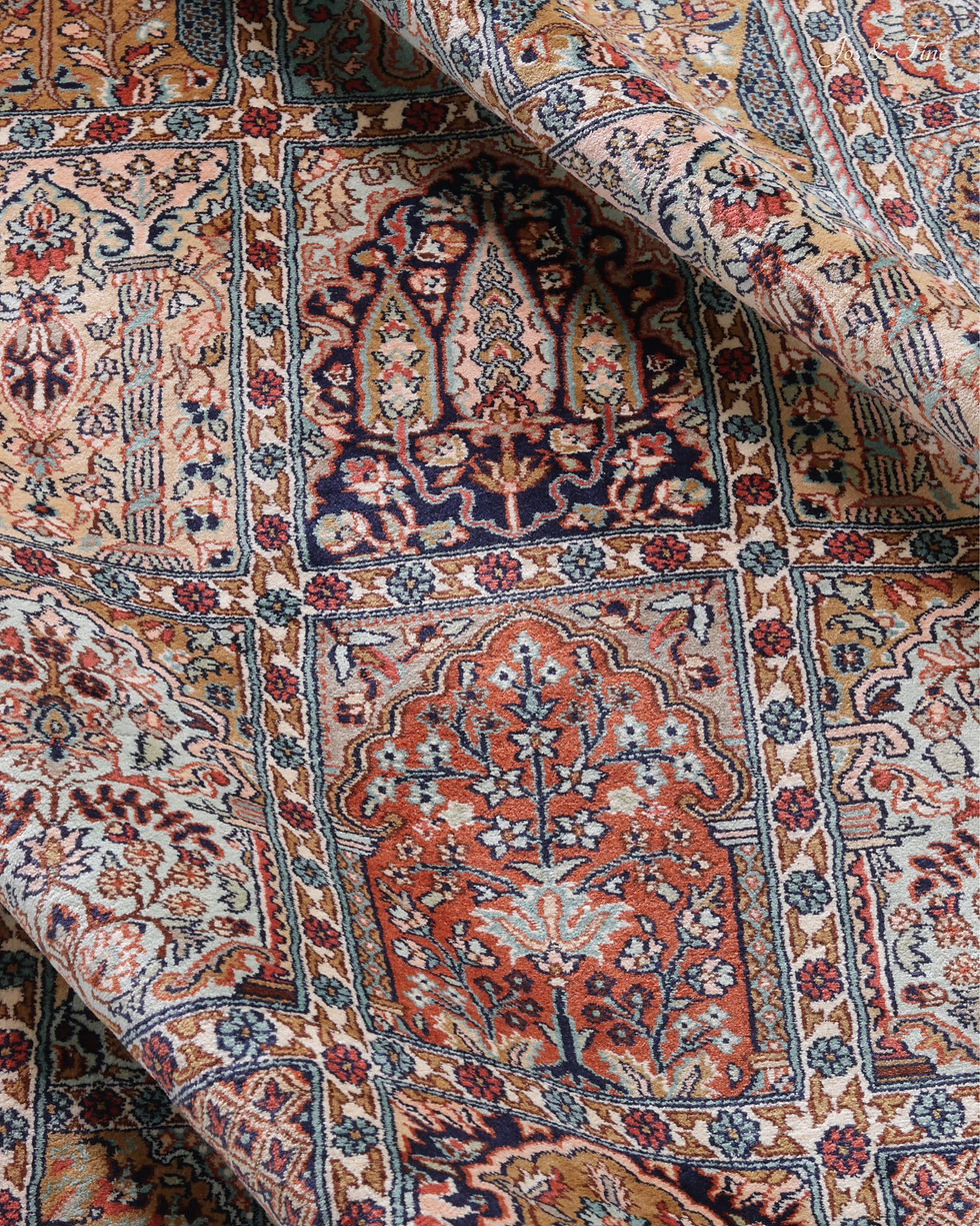 Thumbnail: Macro detail of the Khesti silk rug, featuring central midnight indigo and carmine floral panels.
