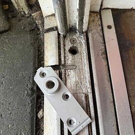 Cutting out for a new bottom piviot bracket on a glass shop front door