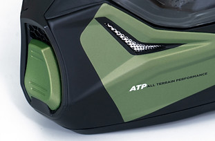 Product photography close-up of a motorbike helmet front, highlighting detailed texture and design on a white background.