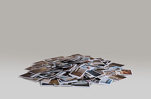 Product photography of a large heap of printed photos showcasing the premium package and extended image set.