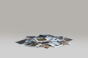 Product photography of a medium pile of photographs representing the standard package and mid-range photo collection.