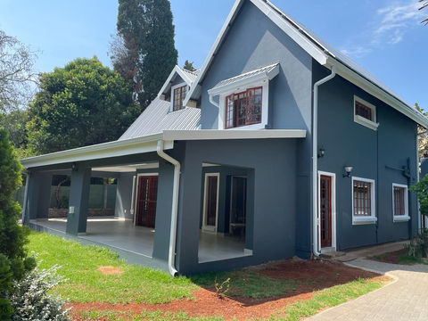 A renovated house with blue paint exterior and white trim. Roof, ceiling.