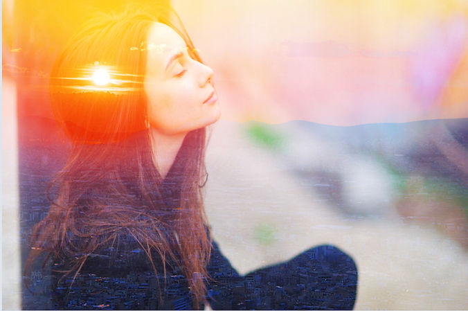 Woman relaxing taking deep breaths_edited.jpg