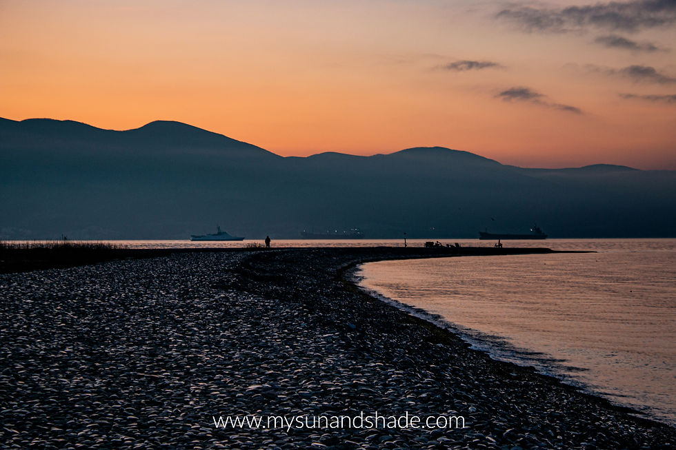 a restful beach at sunset by the mountains