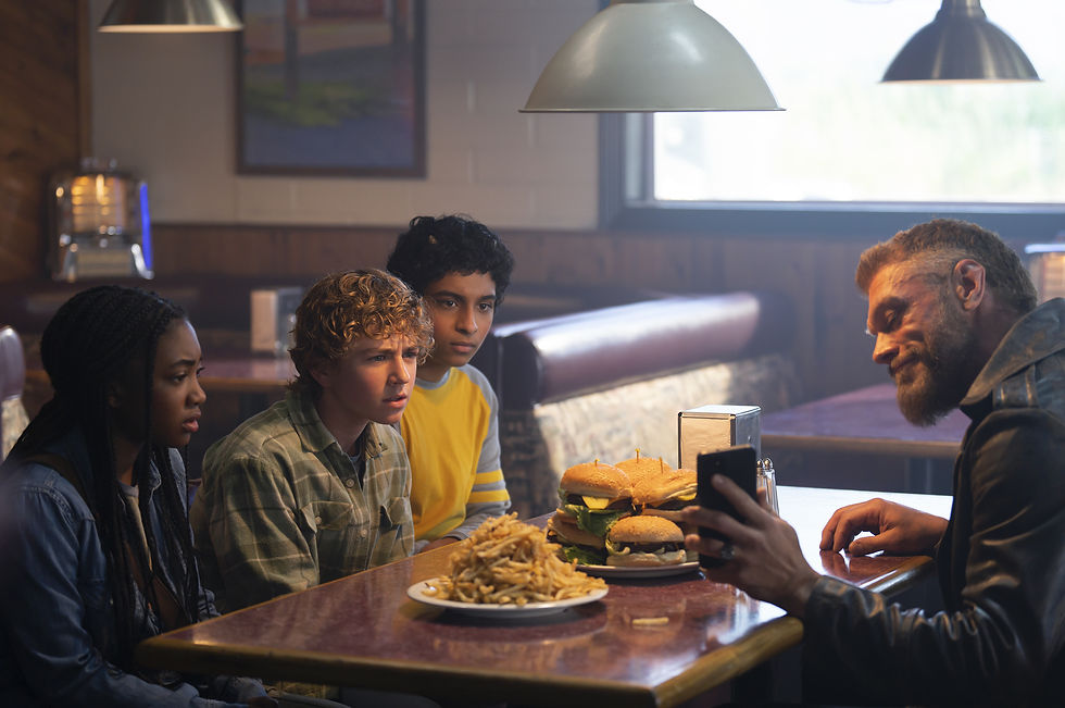Percy, Annabeth, Grover Being Shown Something On Aries' Phone In Percy Jackson And The Olympians.