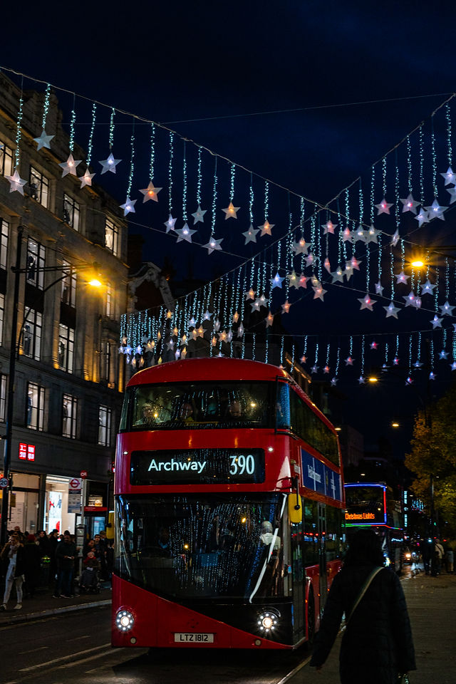 London Bus Driving Through Oxford Street With Christmas Lights On At night.