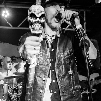 Singer Pushing Skill Themed Staff Towards The Camera During A Show.