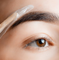 Closeup Master wax depilation of eyebrow hair on woman, brow correction.