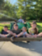 Children on a tractor with dad