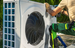 photodune-D3quQ2op-hvac-worker-installing-electric-heat-pump-small
