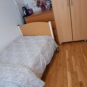 A tidied up bedroom with a small bed