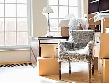chair , lamp table and boxes together in a house