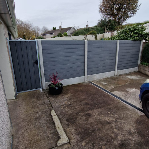 Concrete fence with maintenance free composite boards and composite side gate