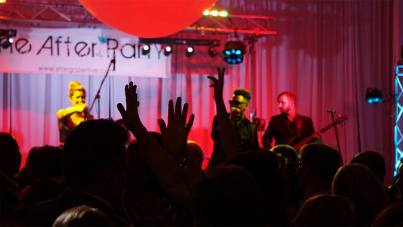 Large ballroom crowd dancing at Dallas International School gala event