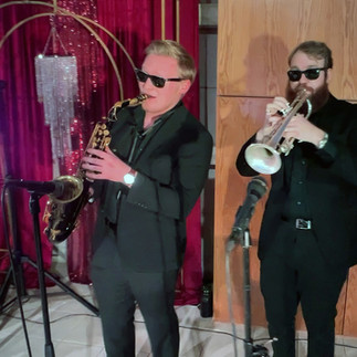 Horn players of The After Party band performing Dallas special event
