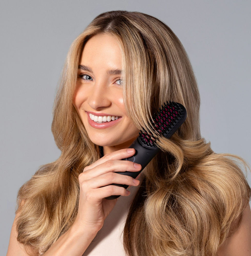 A woman with golden locks smiles as she gently brushes through her hair with a TYMO brush,