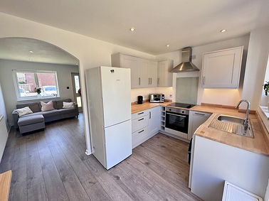 Modern kitchen with a fridge, cabinets, and appliances; Residential Projects.