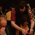 Guests reacting to close-up magic during a 60th birthday celebration in New Jersey