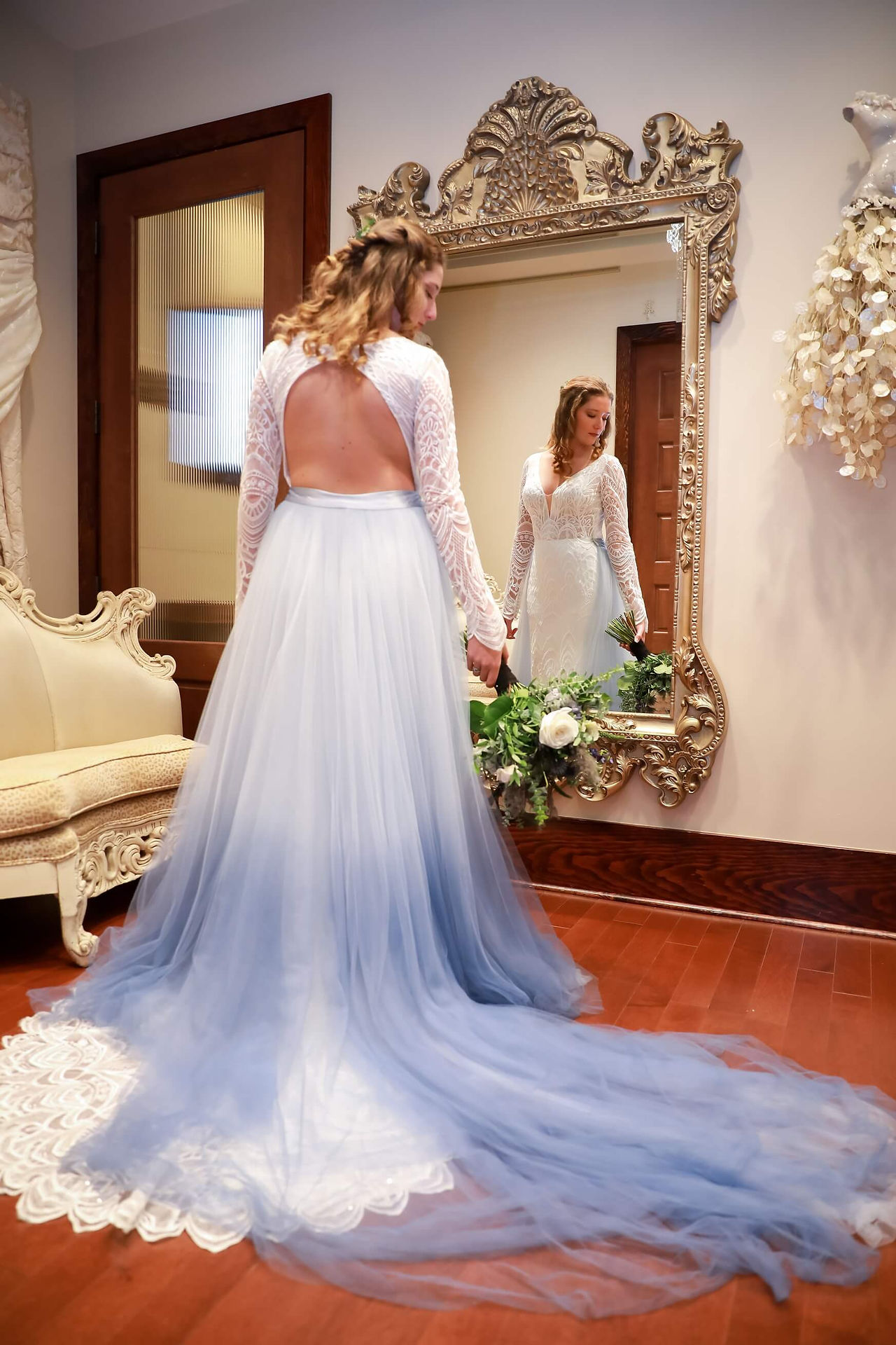 Bride in her white and blue wedding dress