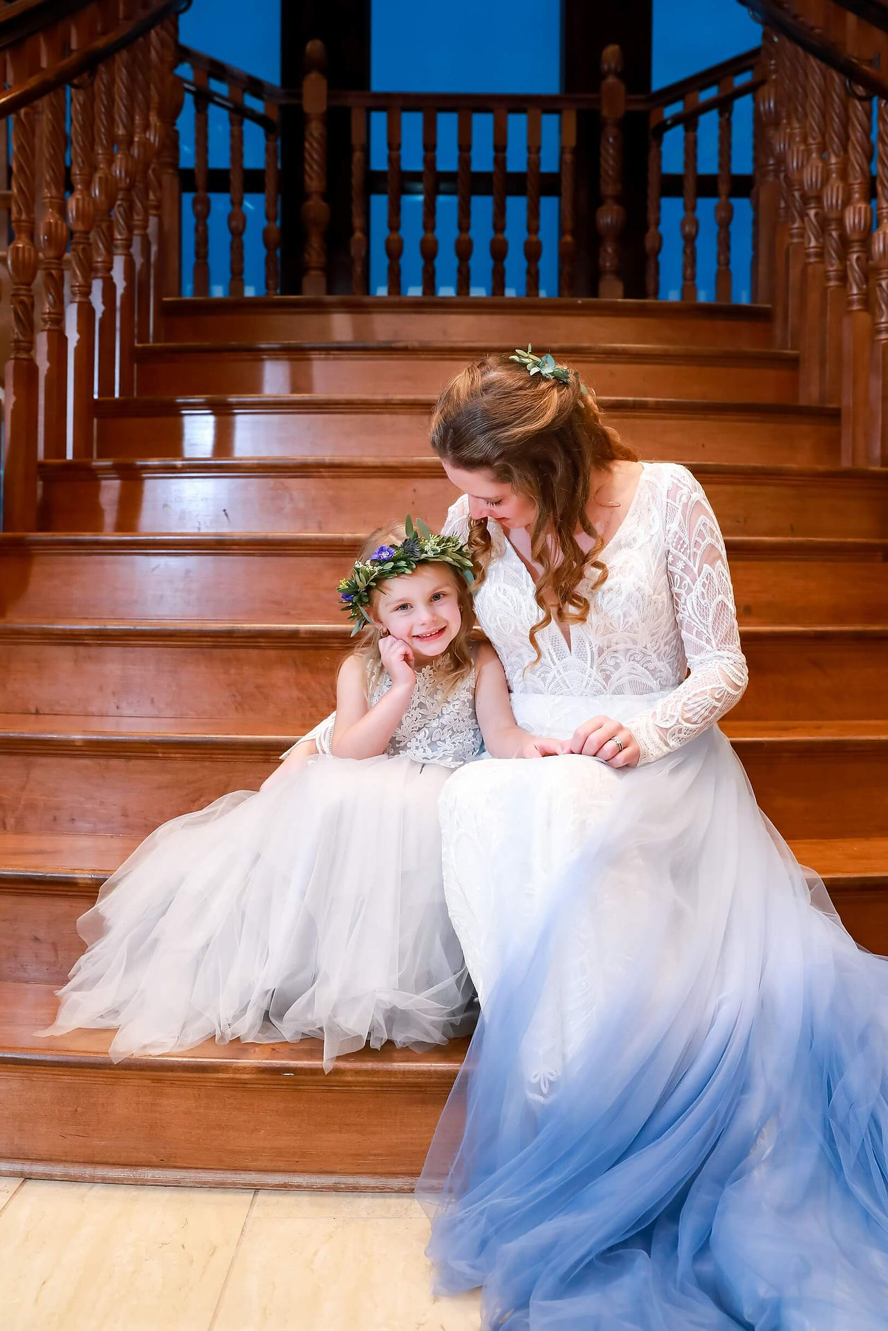 Bride and her flower girl on the stairs