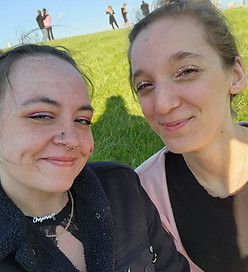 Erin and Cheyenne of Sunny River Pet Services sit outside smiling.