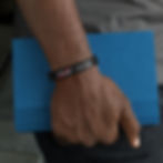 silicone-wristband-mockup-of-a-man-holding-a-book-28233 (1)_edited.jpg