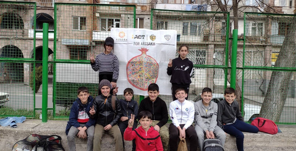 a group of kids poses for a photo in a school yard