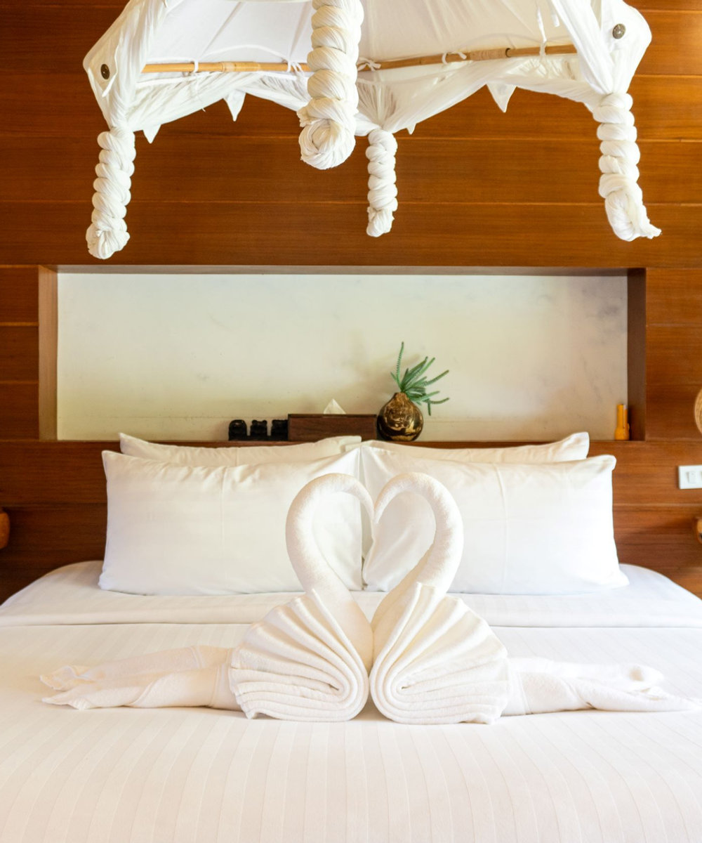 Seaside Pavilion Deluxe Room balcony bathtub with pool and garden view