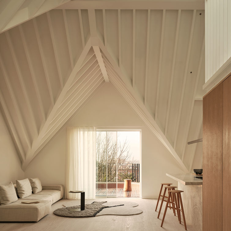An expansive loft conversion integrating elegant roof structure with the architecture.