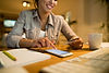 closeup-woman-sing-credit-card-smart-phone-while-shopping-online-night-home.jpg
