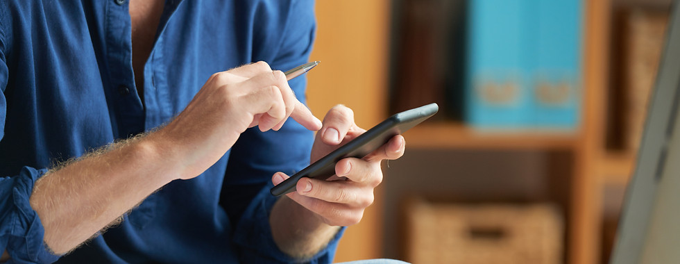 hombre-irreconocible-vestido-informalmente-usando-un-telefono-inteligente-en-el-trabajo-en