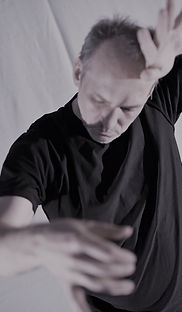 Renee Nommik reaching hands towards camera, gazing downward, photo by Juri Sederenko II