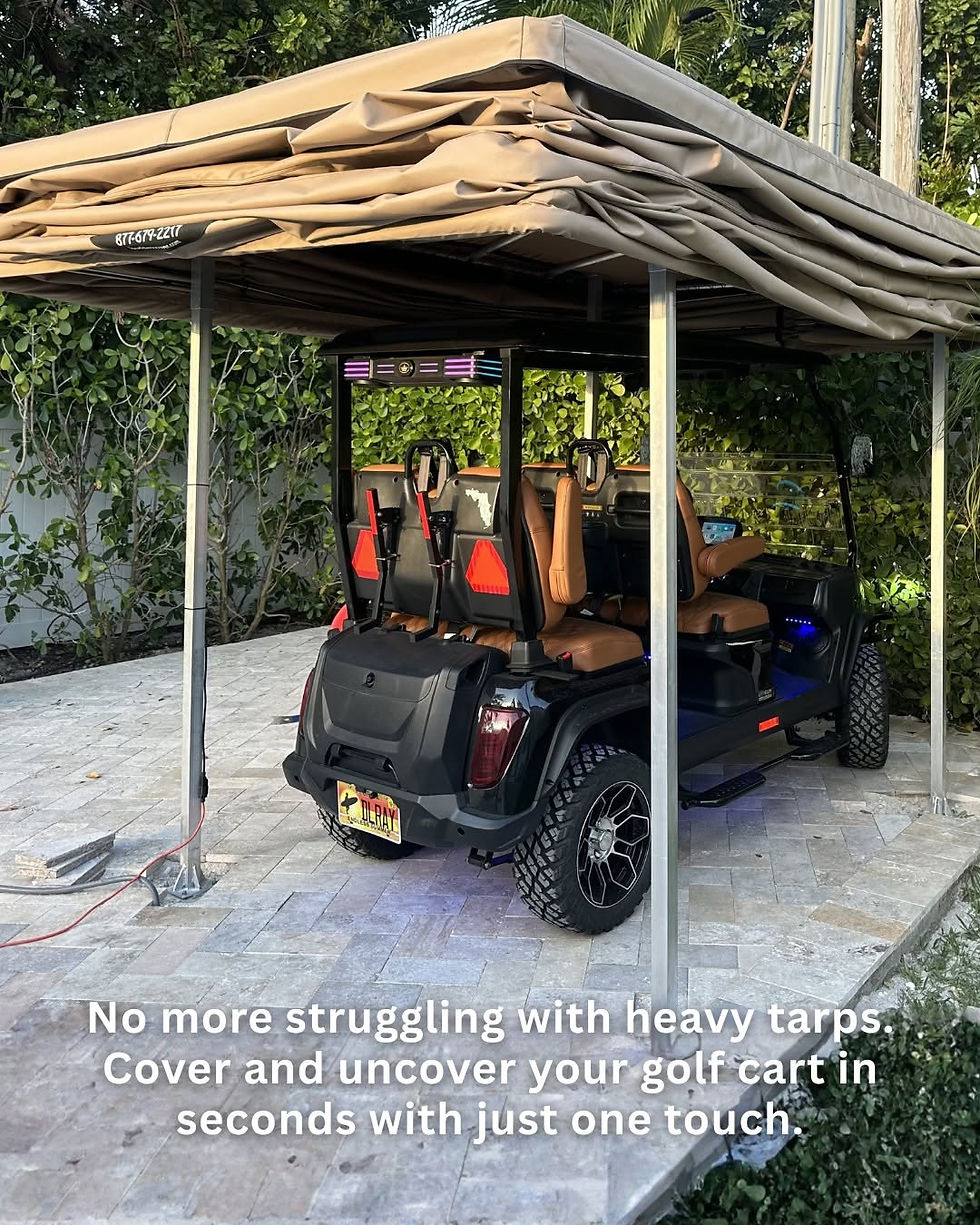 Black golf cart parked outside a garage under a Touchless Cover system on a paved residential driveway.
