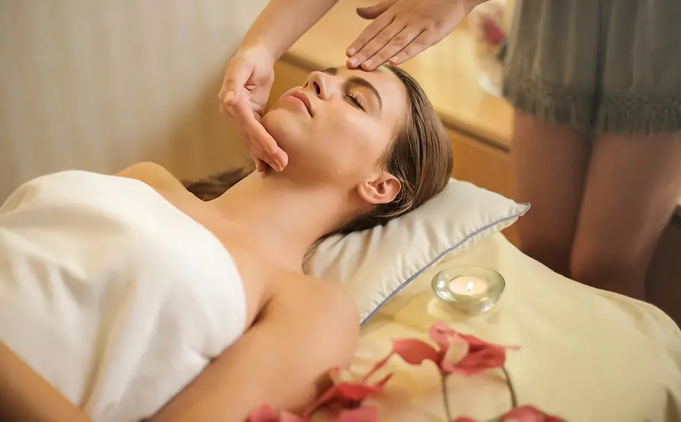 Woman receiving a relaxing facial massage at a spa.