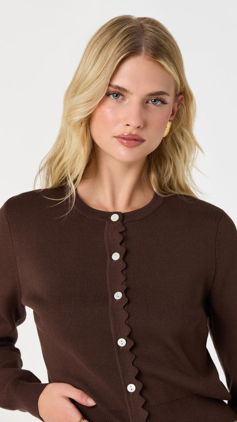 Brown cardigan with scalloped button trim and white buttons