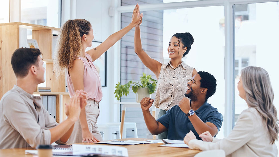 Team celebrates success with high fives and smiles in the office.
