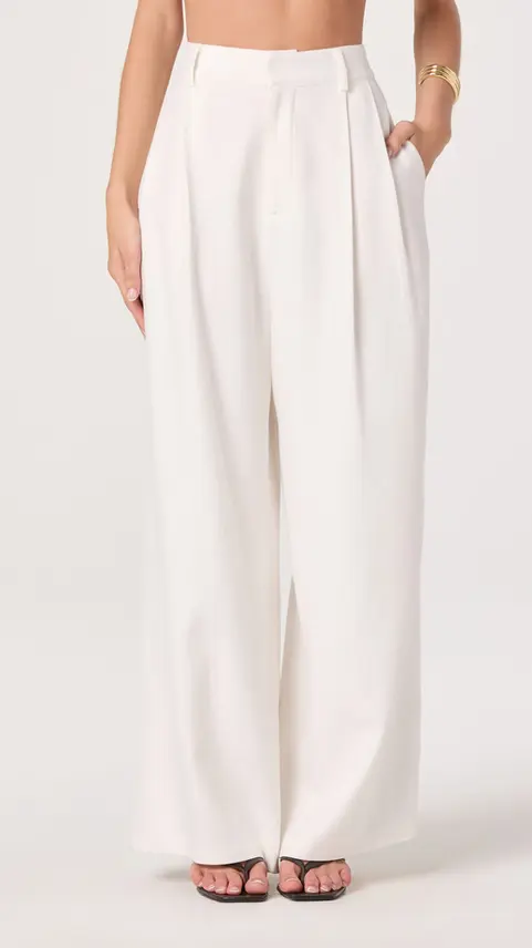Close-up of white wide-leg pleated trousers
