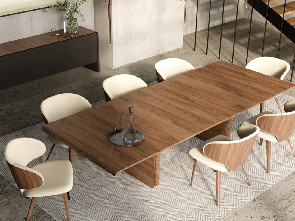 Wooden dining table with chairs and decorative elements in a modern home.