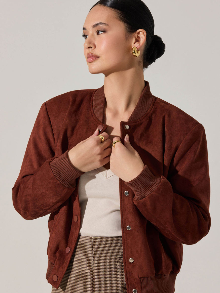 Woman wearing a collarless tailored blazer in brown suede