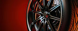 Close-up of a black multi-spoke car wheel and tire.