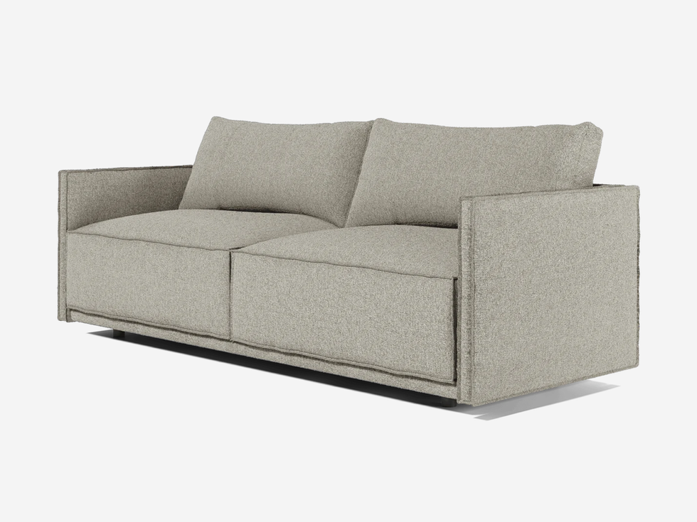 Modern beige sofa with two cushions, perfect for living room space.