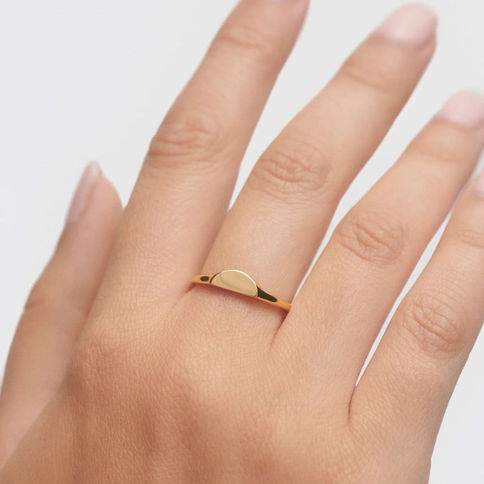 Gold half-circle ring on finger
